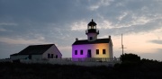Cabrillo National Monument lite in purple in gold to commorate the passing in the 19th amendment for women's right to vote