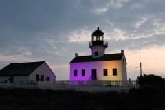 Cabrillo National Monument lite in purple in gold to commorate the passing in the 19th amendment for women's right to vote